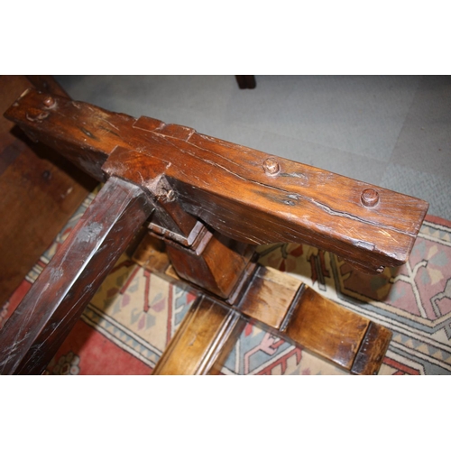 563 - An oak refectory table of early 17th century design with cleated plank top, on twin square baluster ... 