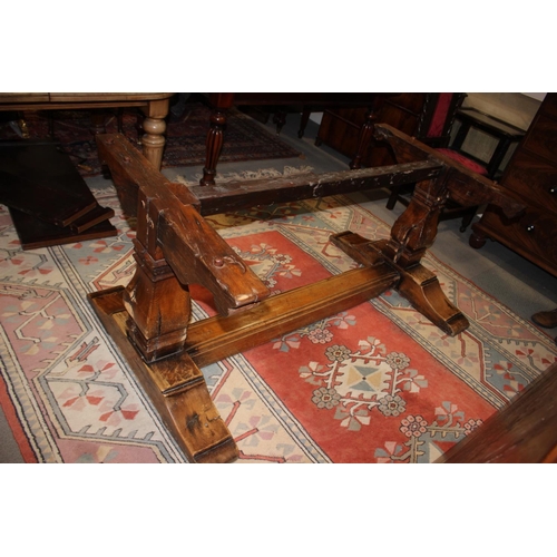 563 - An oak refectory table of early 17th century design with cleated plank top, on twin square baluster ... 