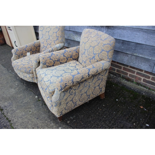 565 - A pair of early 20th century deep seat scroll arm chairs, on square taper castored supports