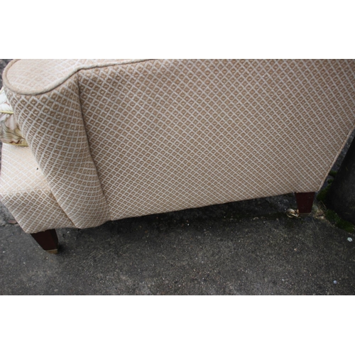 568 - A Dudgeon London scroll armchair with down loose seat cushion, on square taper supports with brass c... 