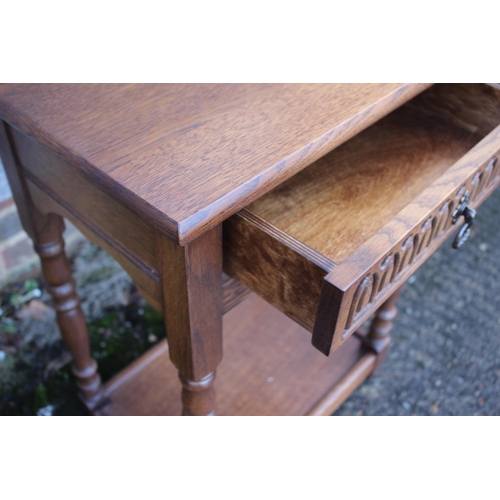 576 - An oak side table, fitted one drawer, on turned supports united by an undertier, 21 1/2