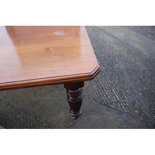 577 - A late Victorian walnut extending dining table with two extra leaves, on turned reeded castored supp... 