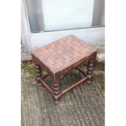 586 - An ebonised oval two-tier occasional table, on bobbin turned support, 20