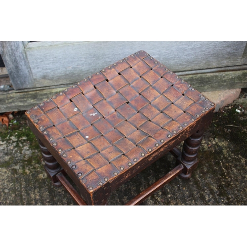 586 - An ebonised oval two-tier occasional table, on bobbin turned support, 20