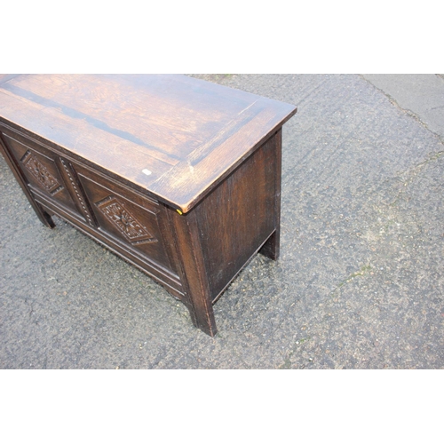 593 - A panelled oak coffer of 17th century design, on stile supports, 42