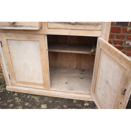 609 - A 19th century pine dresser with plate rack over two drawers and cupboards, on block base, 40 1/2