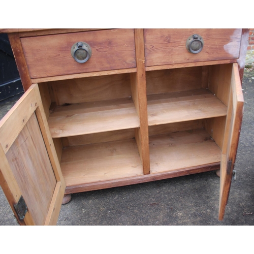 610 - A 19th century pine dresser base, fitted two drawers and cupboards, on stile supports, 42