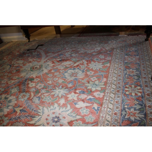 613 - An Egyptian Ziegler wool pile carpet with all-over floral design in shades of blue and cream on a ru... 