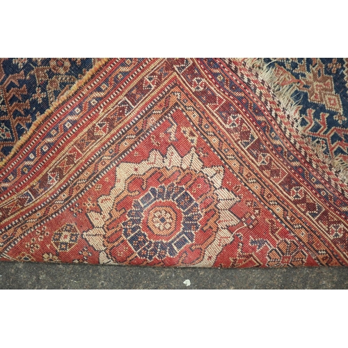 628 - A Hamadan rug with central white medallion on a blue figured ground, 80