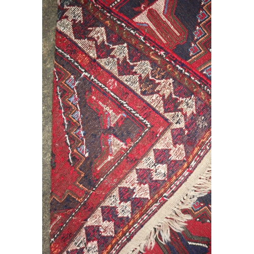 629 - A flat weave tribal rug with six lozenges on a blue ground, 95