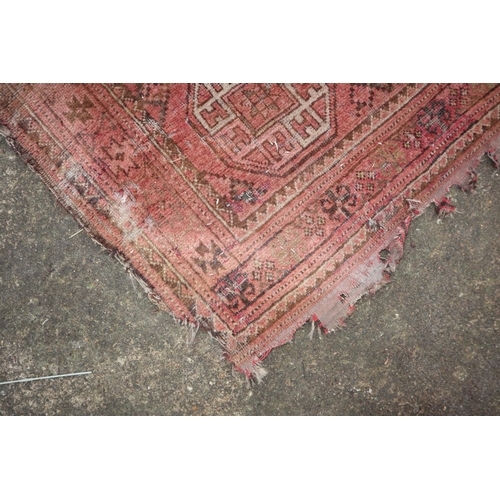 630 - A Bokhara rug with twenty-four guls on a pink ground, 83