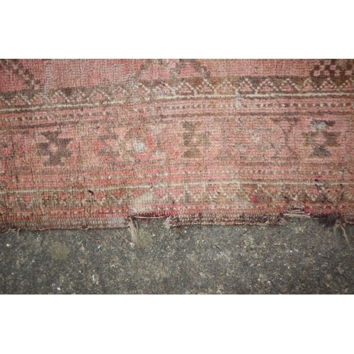 630 - A Bokhara rug with twenty-four guls on a pink ground, 83