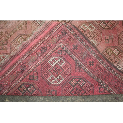 630 - A Bokhara rug with twenty-four guls on a pink ground, 83