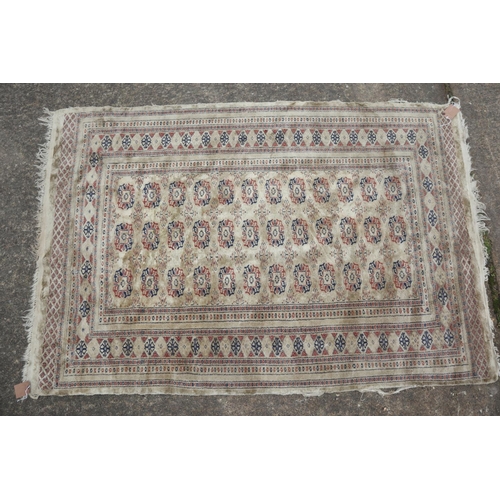 630 - A Bokhara rug with twenty-four guls on a pink ground, 83