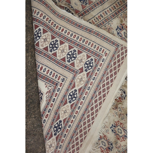 630 - A Bokhara rug with twenty-four guls on a pink ground, 83