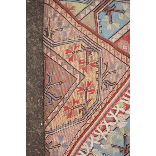 637 - A Milas rug with central panel of five diamond lozenges on a salmon ground and multi-borders, 81