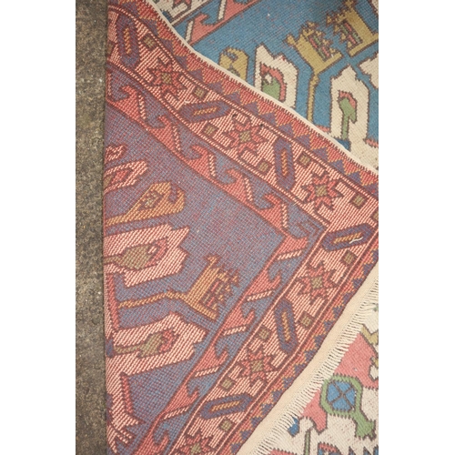 639 - A Kazak rug with two large star medallions on a blue ground, 82