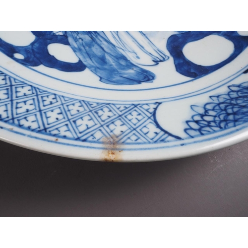 72 - A Chinese blue and white dish, decorated with figures by a house, 11 3/4