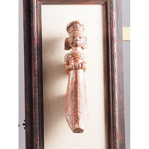 122 - A Balinese hardwood carving, figures amongst trees, 20