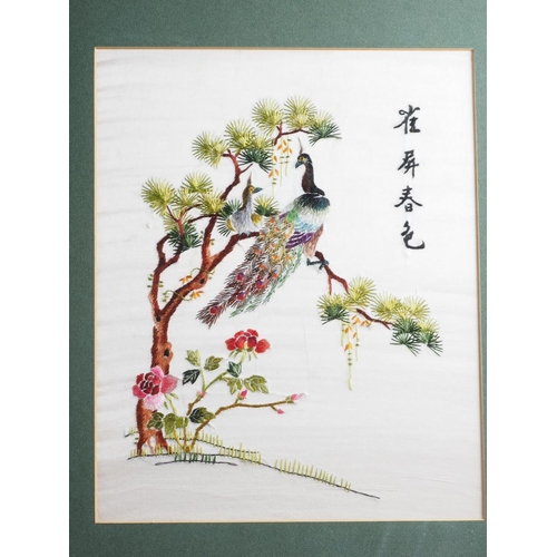 187 - A pair of Chinese embroideries with birds in blooming tree designs, in ebonised frames