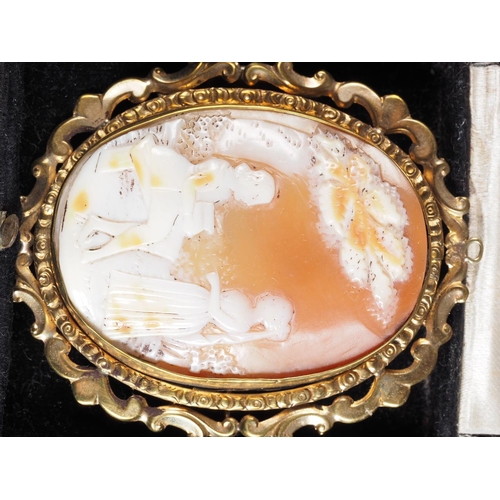 305 - A carved shell cameo, decorated two figures, in yellow metal frame