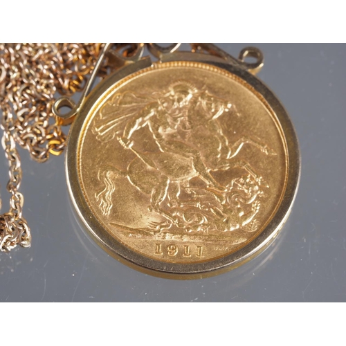 315 - A gold sovereign dated 1911, in 9ct gold frame, on 9ct gold fine link chain, 12.4g gross