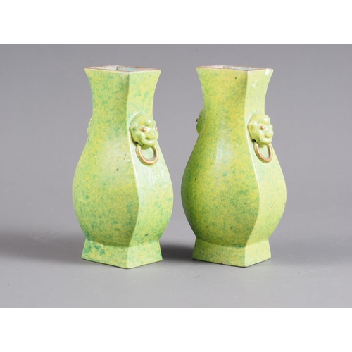 74 - A pair of Chinese green and yellow mottled glaze square-sectioned vases with mask and ring handles, ... 