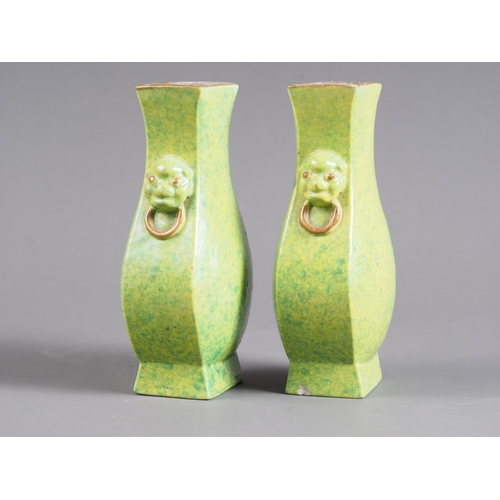 74 - A pair of Chinese green and yellow mottled glaze square-sectioned vases with mask and ring handles, ... 