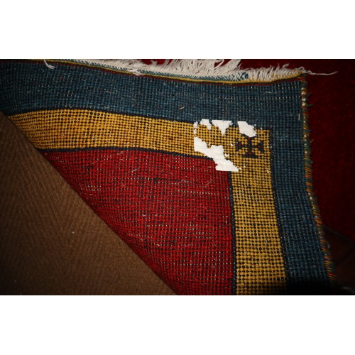 649 - A modern wool pile rug with red centre and yellow and blue bands, 95