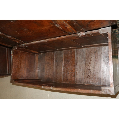 543 - An antique oak three panel front coffer, on moulded stile supports