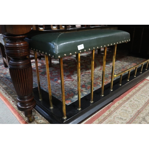 573 - A brass and ebonised club fender, upholstered in a green leather, outside measurements: 83