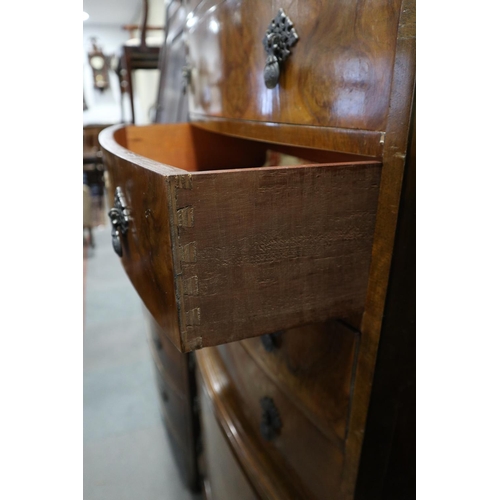 584 - A figured walnut bowfront chest on chest, fitted nine drawers, on cabriole supports, 30 1/2