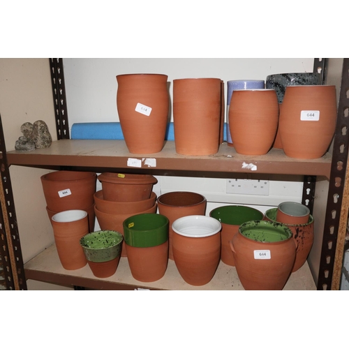 644 - A quantity of terracotta plant pots, some with interior glazed decoration, smallest 4 1/2