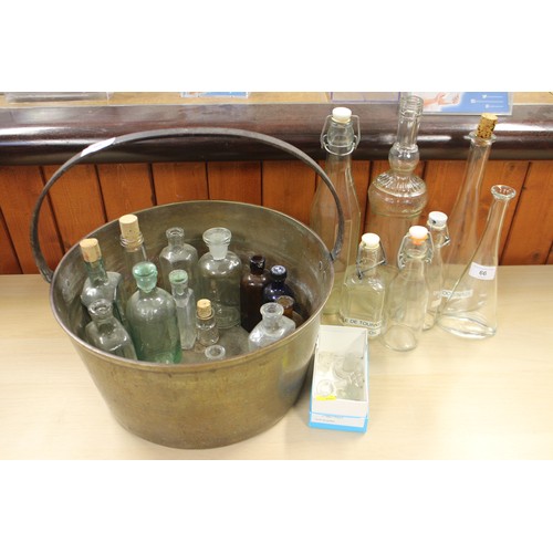 66 - A collection of glass bottles, various, a clear cut glass ceiling light shade, a similar alabaster s... 