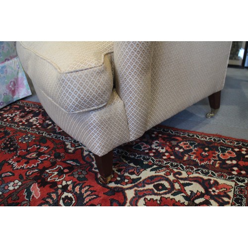 568 - A Dudgeon London scroll armchair with down loose seat cushion, on square taper supports with brass c... 