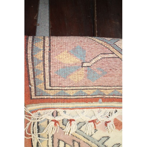 616 - A Milas carpet with four medallions on a rust centre ground with bold geometric borders, 130