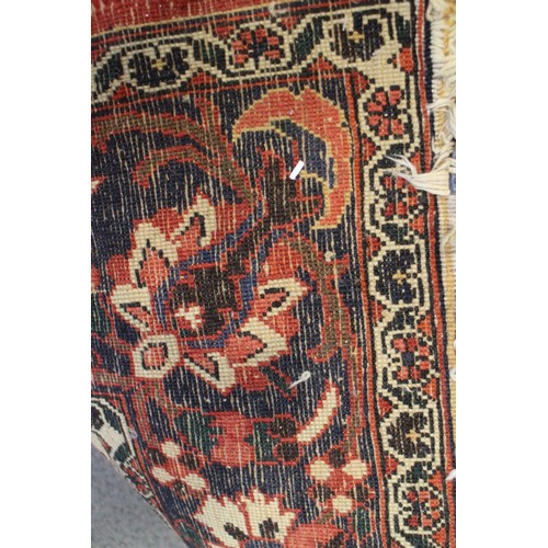 619 - A Persian city rug with all-over floral design on a red ground, 83