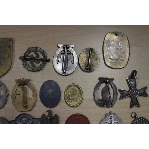 387 - A quantity of Nazi medals and badges, including a Kriegsmarine Destroyer Navy badge, a War Merit Cro... 