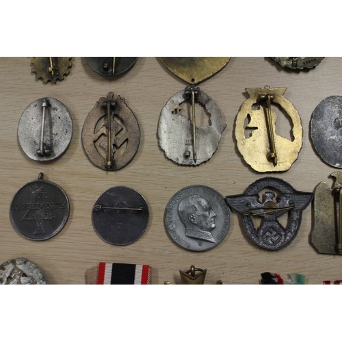 387 - A quantity of Nazi medals and badges, including a Kriegsmarine Destroyer Navy badge, a War Merit Cro... 