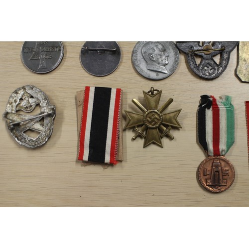 387 - A quantity of Nazi medals and badges, including a Kriegsmarine Destroyer Navy badge, a War Merit Cro... 