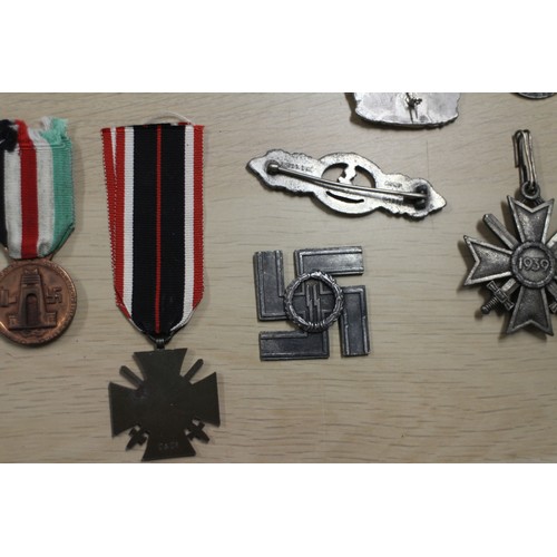 387 - A quantity of Nazi medals and badges, including a Kriegsmarine Destroyer Navy badge, a War Merit Cro... 