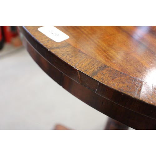 520 - An early 19th century mahogany and rosewood banded circular top occasional table, on carved column a... 