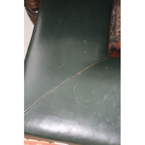 573 - A brass and ebonised club fender, upholstered in a green leather, outside measurements: 83