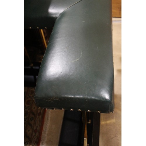 573 - A brass and ebonised club fender, upholstered in a green leather, outside measurements: 83