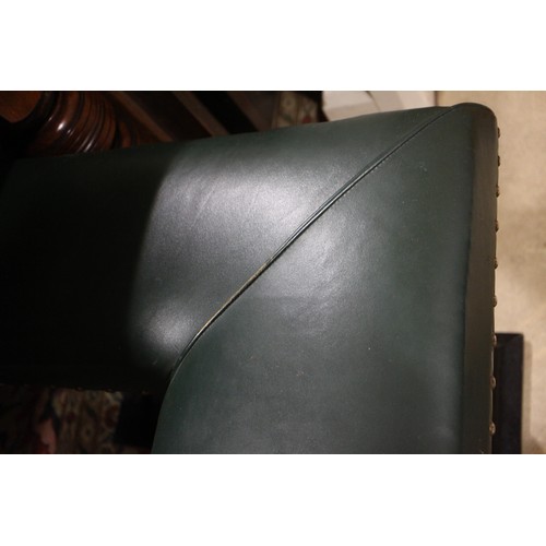 573 - A brass and ebonised club fender, upholstered in a green leather, outside measurements: 83