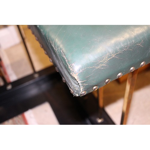 573 - A brass and ebonised club fender, upholstered in a green leather, outside measurements: 83