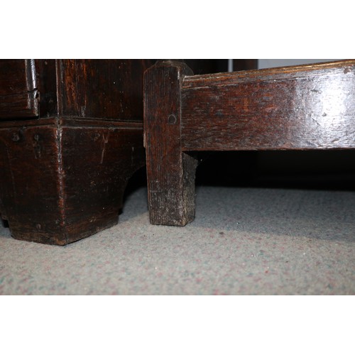 486 - A late 18th century oak dresser, the upper section with open plate shelves over three drawers with b... 