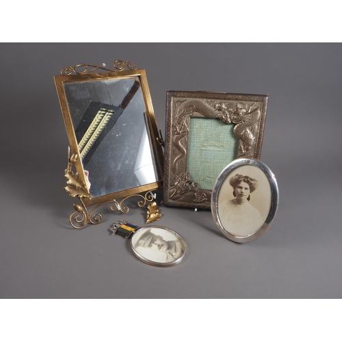 362 - Two oval silver photo frames, one with portrait of a soldier, an Oriental picture frame, decorated d... 