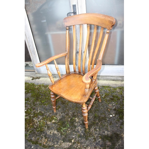 548 - A Windsor lath back farmhouse elbow chair with elm panel seat