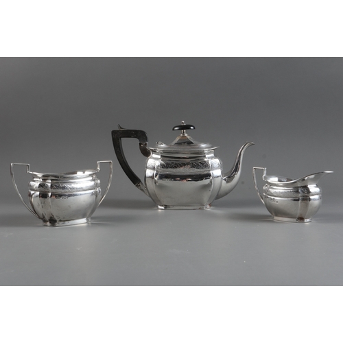 363 - A silver three-piece teaset with bright cut decoration and ebonised knop and handle, 17.6oz troy app... 